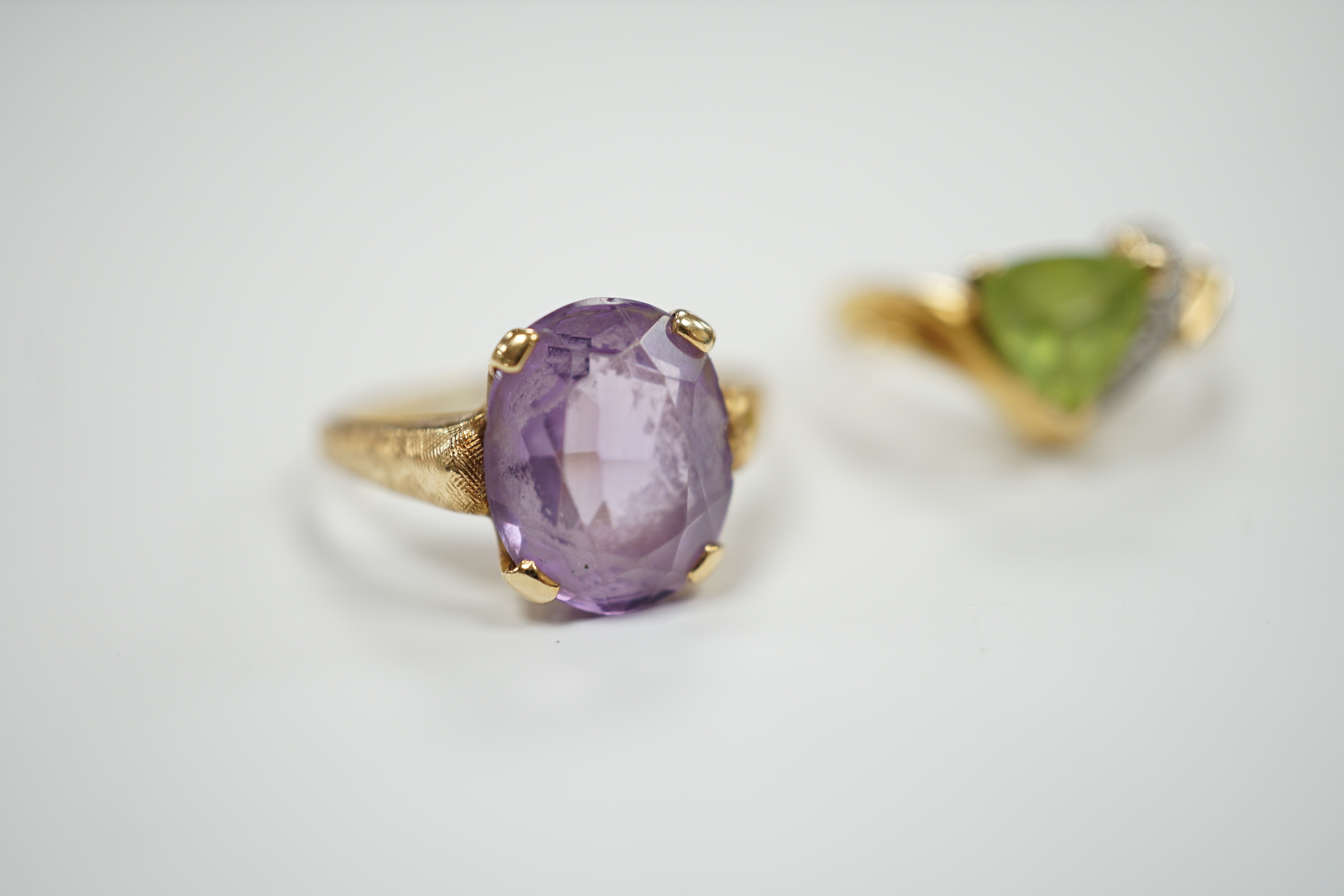 Two modern 14k and gem set dress rings, including amethyst, size P/Q, gross weight 6 grams.